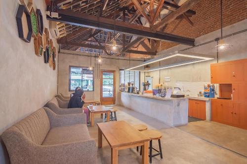 a room with a table and chairs and a kitchen at RedDoorz near Alun-Alun Garut in Garut