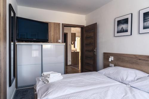 Katil atau katil-katil dalam bilik di TATRYSTAY Tatrahouse Luxury Apartment