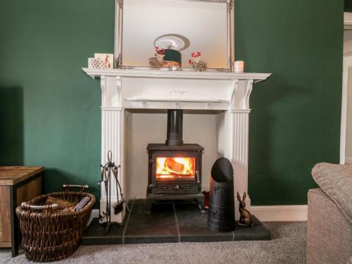 a fireplace in a living room with a stove at Ivy Bank in Thornhill
