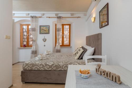 um quarto com uma cama e uma mesa em Divina Blue Apartments em Dubrovnik