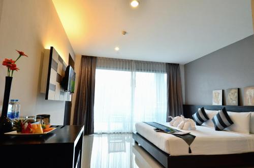 a hotel room with a bed and a window at Chaweng Noi Pool Villa in Chaweng Noi Beach
