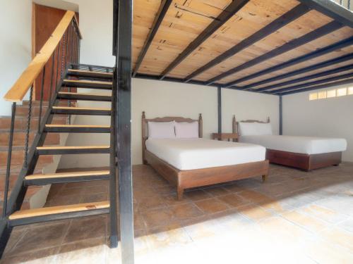 Ένα ή περισσότερα κρεβάτια σε δωμάτιο στο HOTEL EX HACIENDA EL MOLINO