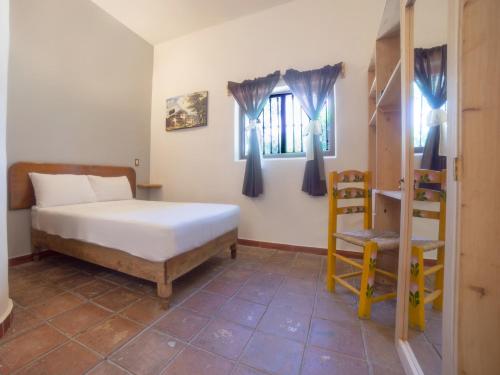 Ένα ή περισσότερα κρεβάτια σε δωμάτιο στο HOTEL EX HACIENDA EL MOLINO