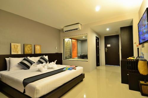 a bedroom with a large bed and a television at Chaweng Noi Pool Villa in Chaweng Noi Beach