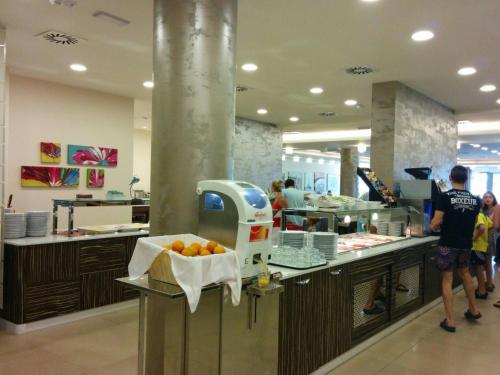 a kitchen with a bunch of oranges on a counter at Hotel Lido Bibione Beach in Bibione