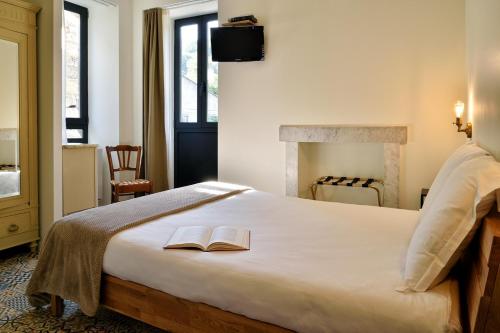 a bedroom with a bed with two books on it at A Bella Scusa in Bastelica