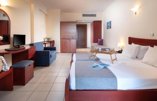 a hotel room with a bed and a living room at Lesse Hotel in Hanioti