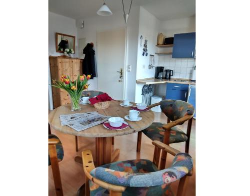 a kitchen and dining room with a wooden table and chairs at Koserow_Jugendweg_FeWo 16 in Ostseebad Koserow