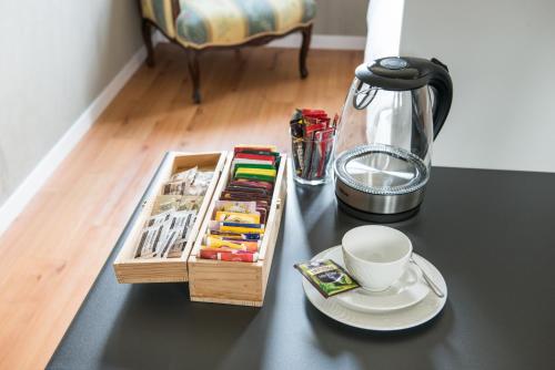 a black table with a tray with a cup of coffee at Point Hotel in Piove di Sacco