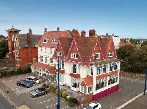 a group of buildings in a city with a parking lot at Marine Lodge in Great Yarmouth