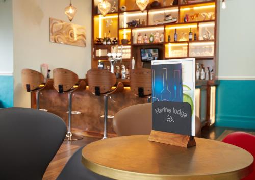 a table with a book sitting on top of a bar at Marine Lodge in Great Yarmouth