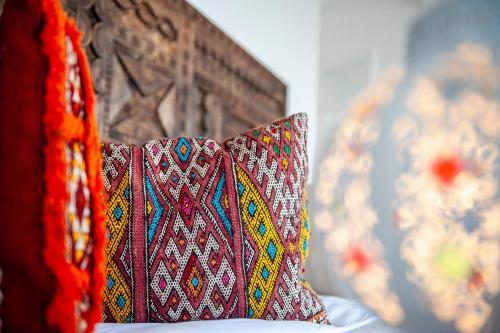 a couple of pillows sitting on a bed at PK25 Dakhla in Dakhla