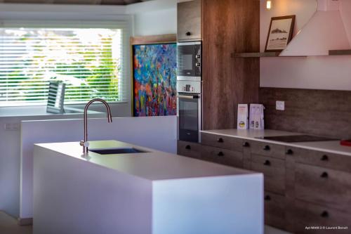 a kitchen with a white counter and a sink at Dream Villa Gustavia 849 in Gustavia
