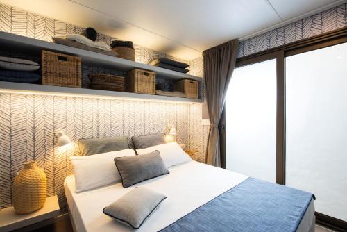 a bedroom with a bed, desk, and window at Villaggio Camping Torre Del Porticciolo in Porto Conte