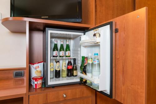 an open refrigerator filled with lots of drinks at Point Hotel in Piove di Sacco