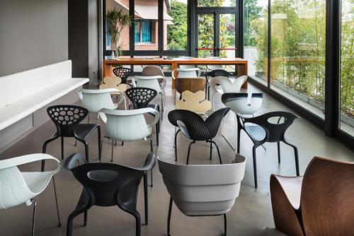 a row of chairs in a room with windows at Point Hotel in Piove di Sacco