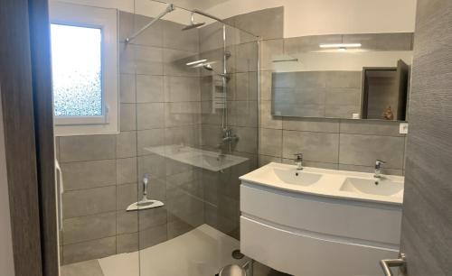 a bathroom with a sink and a glass shower at Boost Your Immo Six Fours Les Plages Le Mistral 253 in Six-Fours-les-Plages