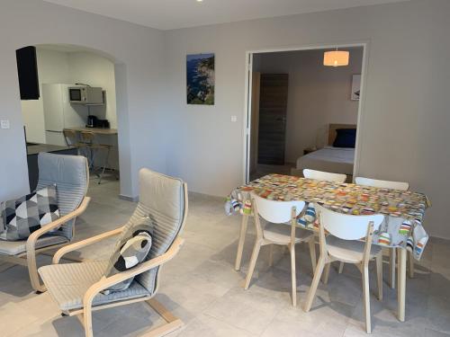 a dining room with a table and chairs and a bed at Boost Your Immo Six Fours Les Plages le Mistral 252 in Six-Fours-les-Plages