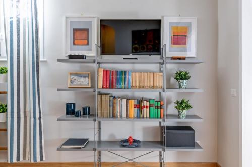 a book shelf filled with books in a room at Rome as you feel - Grotta Pinta apartments in Rome