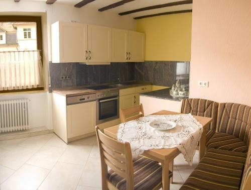 a kitchen with a table and a table and chairs at Weinhaus Burg-Schneider in Reil
