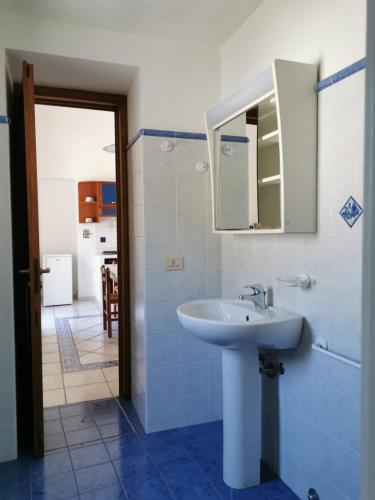 a bathroom with a sink and a mirror at ANFORA Blu in Canneto