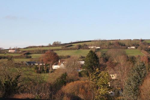 a view of a field with houses on a hill at The Haymaker Inn in Chard