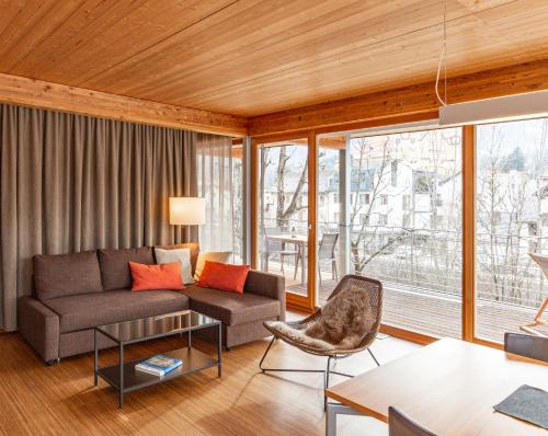 a living room with a couch and a table at Kronplatz LOFT Bruneck in Brunico