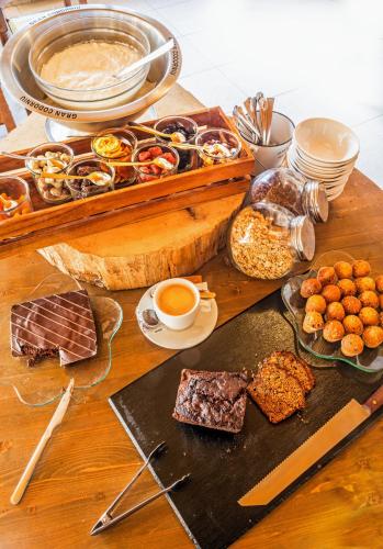 a table topped with lots of different types of food at Apartaments Trainera in Esterri d'Àneu
