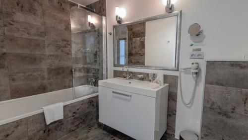 a bathroom with a white sink and a shower at Chateau Appony in Oponice