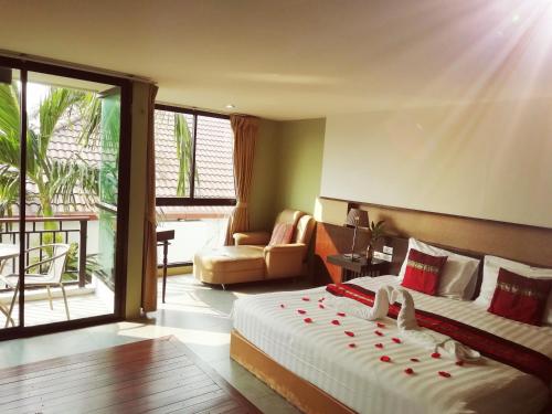 a bedroom with a bed and a living room at Mandala House, Chiang Mai in Chiang Mai