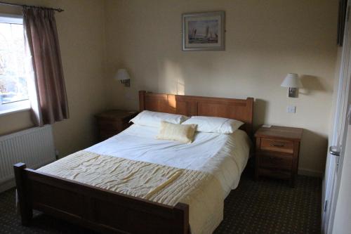 a bedroom with a large bed and a window at The Haymaker Inn in Chard