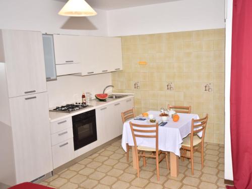 a kitchen and dining room with a table and chairs at Studio Green Marine- Palme- Ismare-11 by Interhome in Silvi Marina