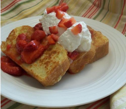 a white plate with two pieces of toast with strawberries and cheese at Suzhou Blue Gate Youth Hostel in Suzhou