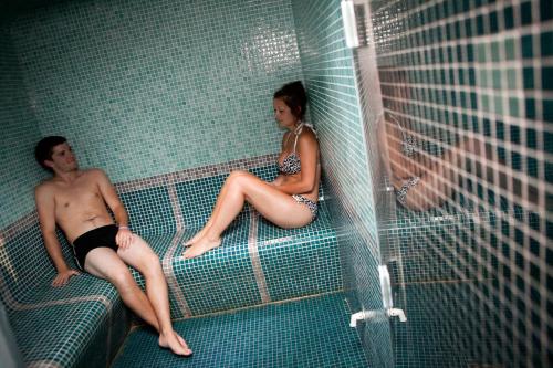 a man and a woman sitting in a bird cage at Camping Signol in Boyard-Ville