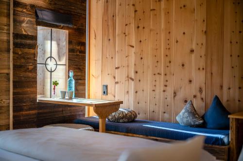a room with a blue bench in a wooden wall at mama thresl in Leogang