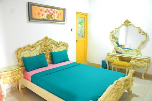 a bedroom with a blue bed and a mirror at Green Heritage Holiday Resort in Mahiyangana