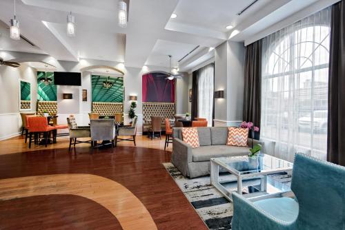 a living room with a couch and chairs at Hotel Indigo Houston at the Galleria, an IHG Hotel in Houston