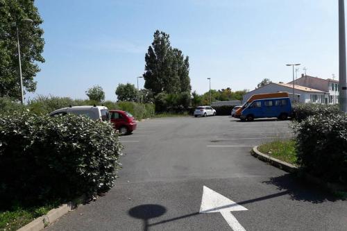 a parking lot with several cars parked in it at La Virginie - Suite Parée'Ô in La Couarde-sur-Mer