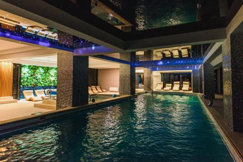 an indoor swimming pool in a house at HOTEL CARPAT INN in Azuga