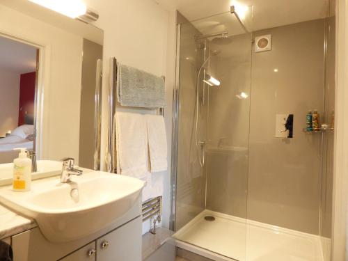 a bathroom with a shower and a sink and a shower at Highfield House, Parracombe, Modern B&B in Parracombe