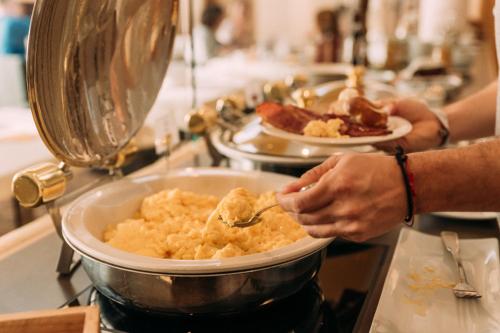 a person is preparing food in a pot at Hotel Bären Titisee in Titisee-Neustadt