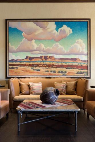 a living room with a couch with a painting on the wall at Hyatt Regency Tamaya South Santa Fe in Santa Ana Pueblo