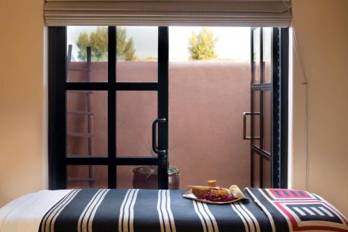 a table with a plate of food in front of a window at Hyatt Regency Tamaya South Santa Fe in Santa Ana Pueblo
