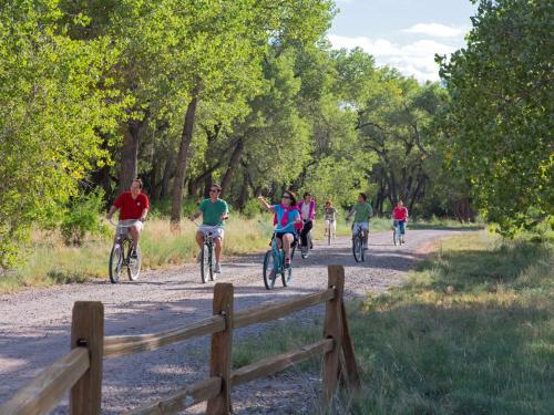 a group of people riding bikes down a dirt road at Hyatt Regency Tamaya South Santa Fe in Santa Ana Pueblo