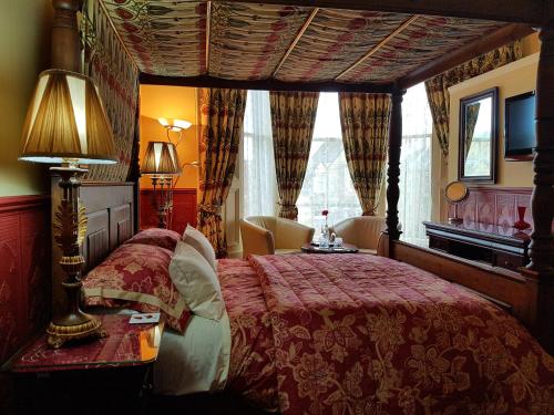 a bedroom with a bed with a red bedspread at Lauderville guest house in Edinburgh