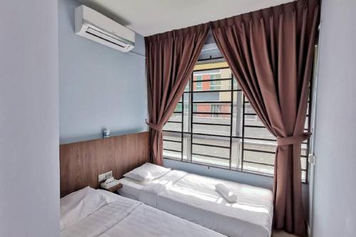 a bedroom with two beds and a large window at Comfort home 5min to Airport 15min to city center 近机场 适合小家庭 安静小区 in Penampang