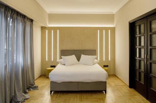 En eller flere senge i et værelse på Soho Apartments