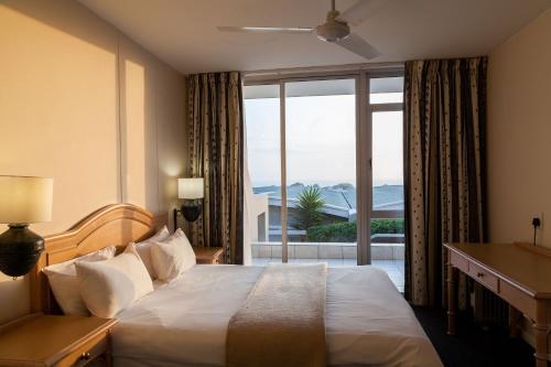 A bed or beds in a room at Dolphin Beach Hotel Self Catering Apartments