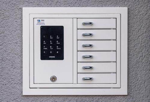 a white cabinet with a remote control on it at Hotel Zu Freunden in Hamm