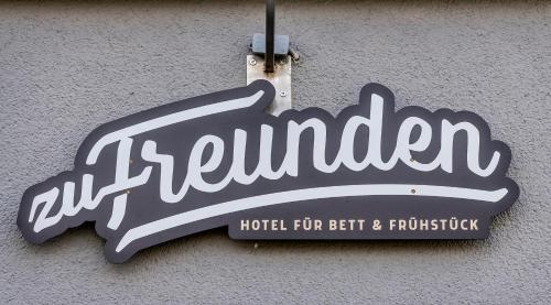 a sign for a hotel for better and profitable at Hotel Zu Freunden in Hamm